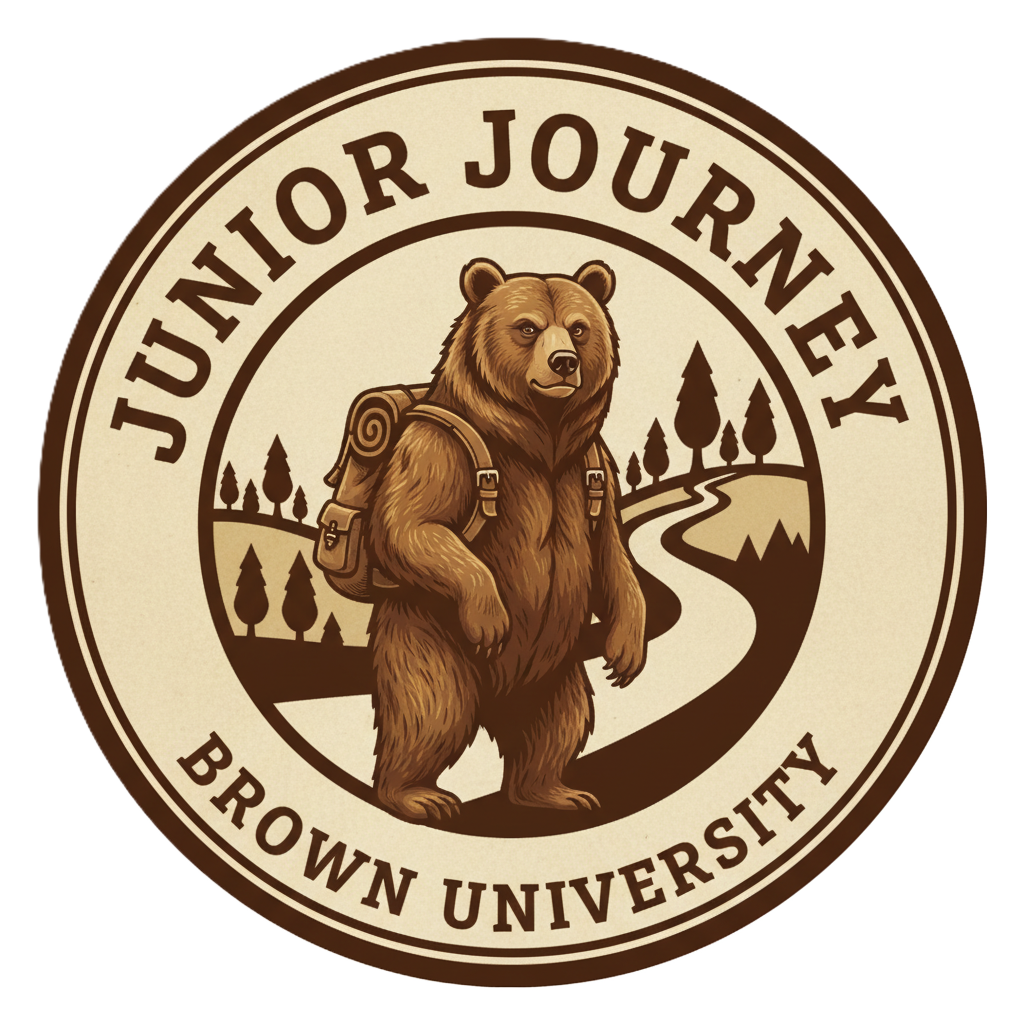 Bear with backpack on, walking down a road. Jumior Journey and Brown University written above and below the circular logo, shades of brown.