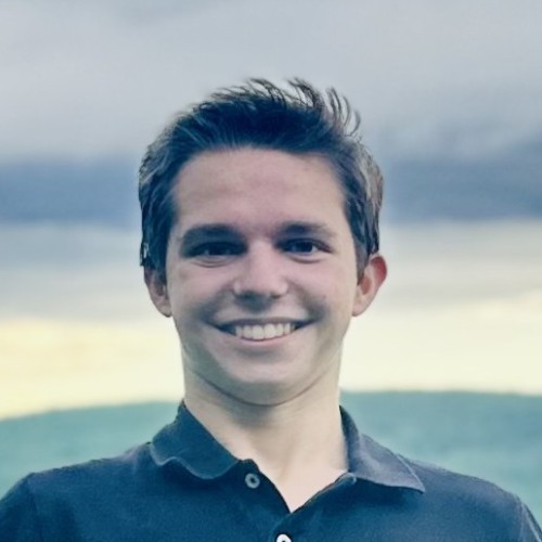 Headshot of Neil Stringer with hill landscape and sky in background