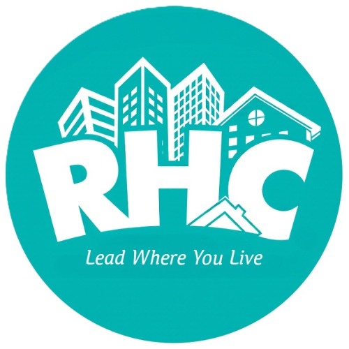 Aqua background with white drawing of skyline with buildings, RHC under the buildings.