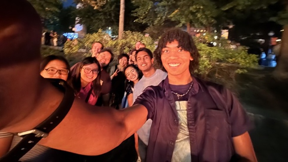 Group of students standing together for a "selfie" at the Providence waterfront.